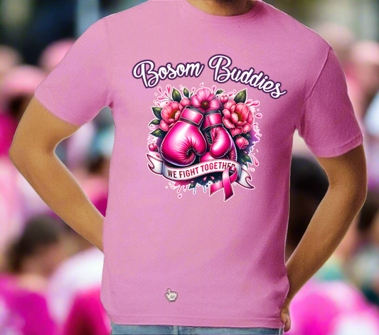 Person wearing a pink t-shirt with 'Bosom Buddies' design featuring boxing gloves and flowers.